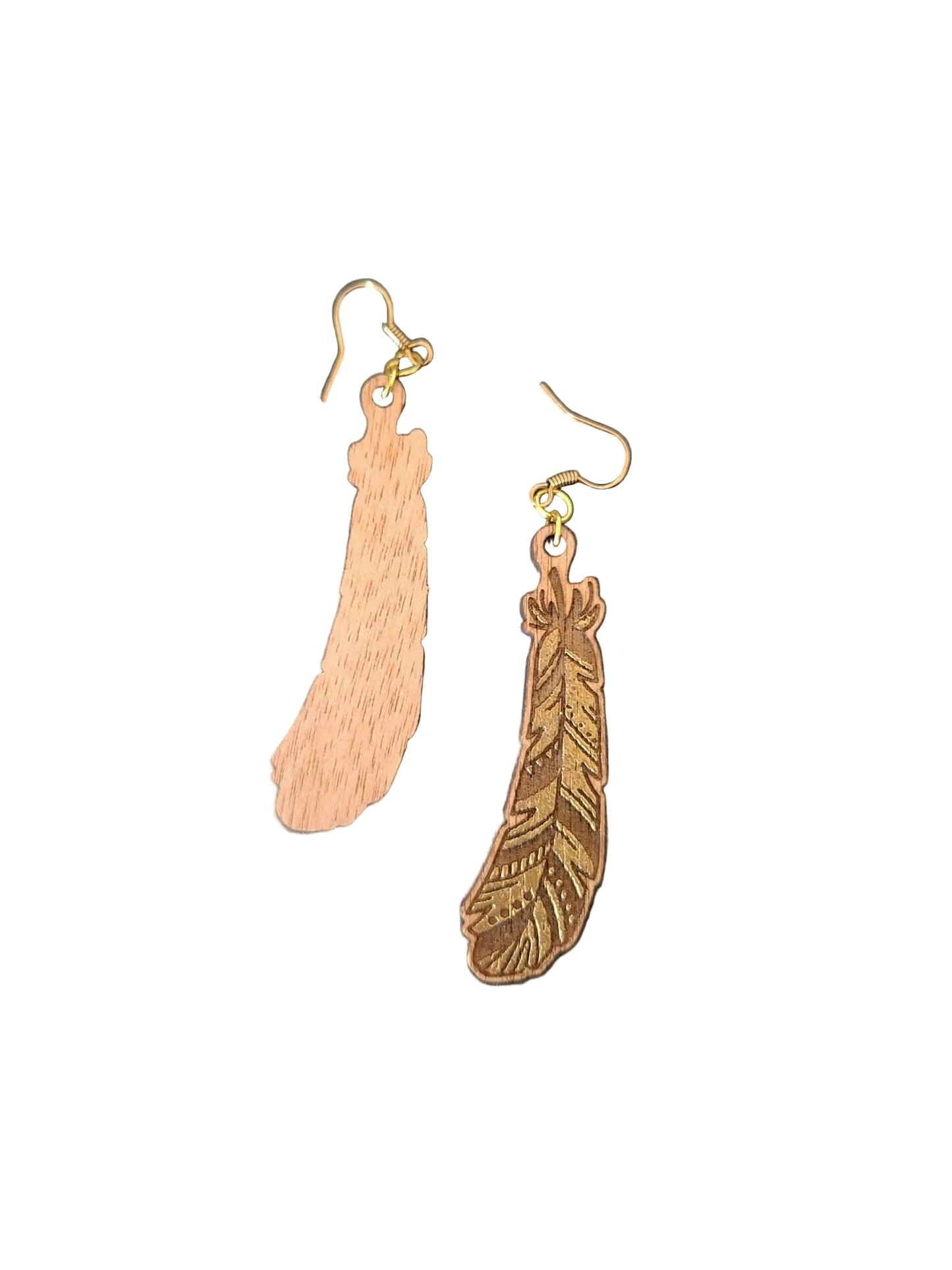 Two feather-shaped dangle earrings in natural wood tones with gold-tone fishhook ear wires, displayed on a dark textured surface.
