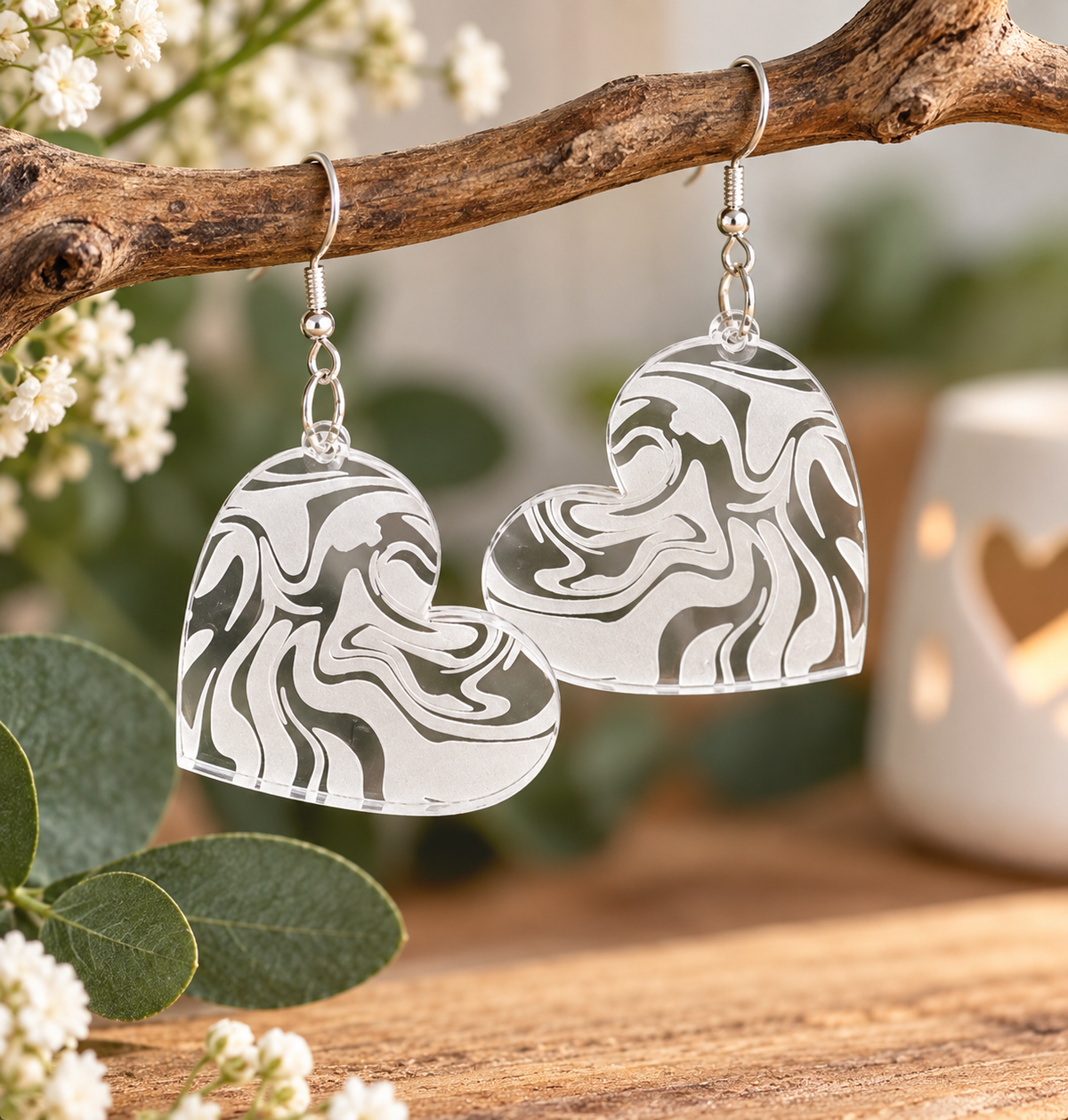 Clear acrylic heart earrings with white engraved swirl pattern, laser cut and made in New Zealand by Dopey Dog NZ.