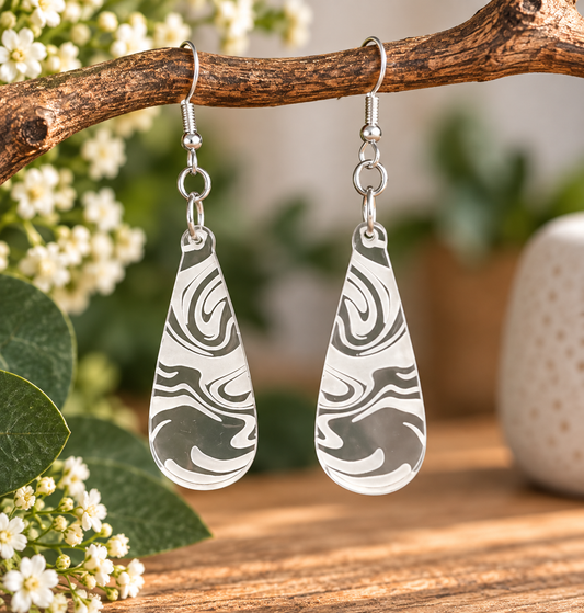 Clear acrylic teardrop earrings with white engraved swirl pattern, laser cut and made in New Zealand by Dopey Dog NZ.